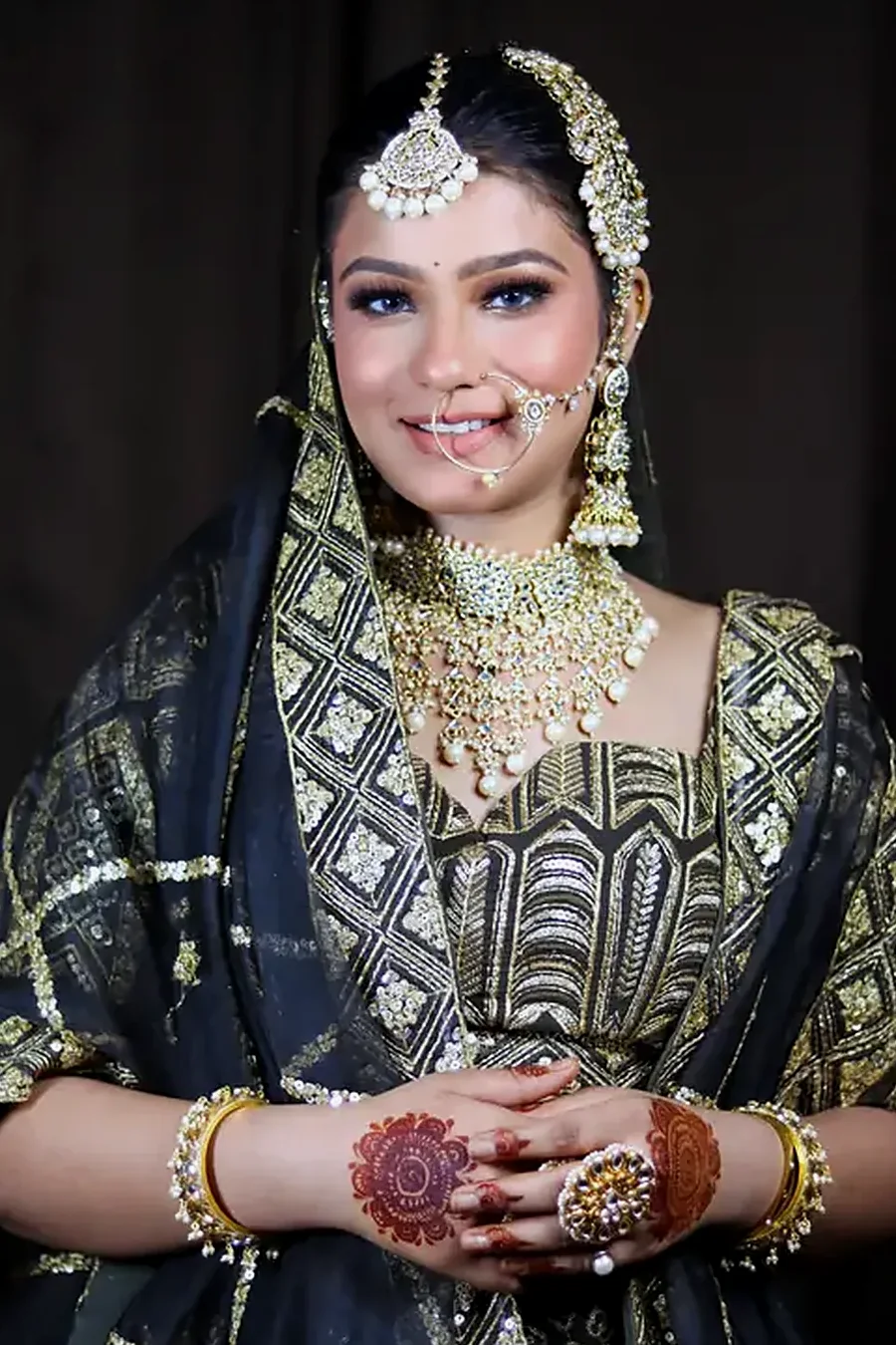 Bride in a navy lehenga, soft glam by Mona Sharma